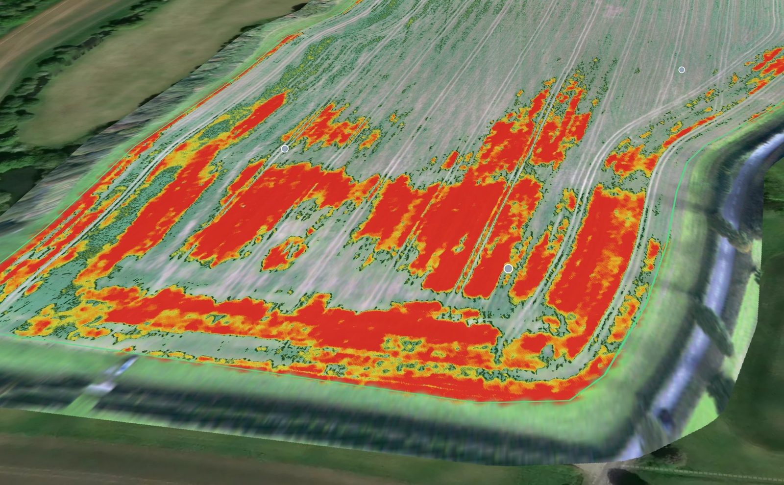 A 3D weed map of an oilseed rape field. Red and orange patches mark the weeds along the headland and across the lower half of the field; the rest of the crop is clean.